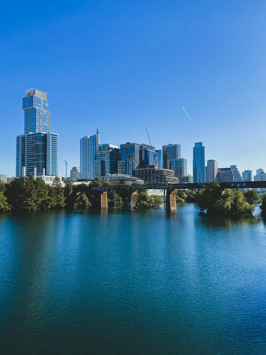 Austin skyline over Lady Bird Lake under a clear blue sky