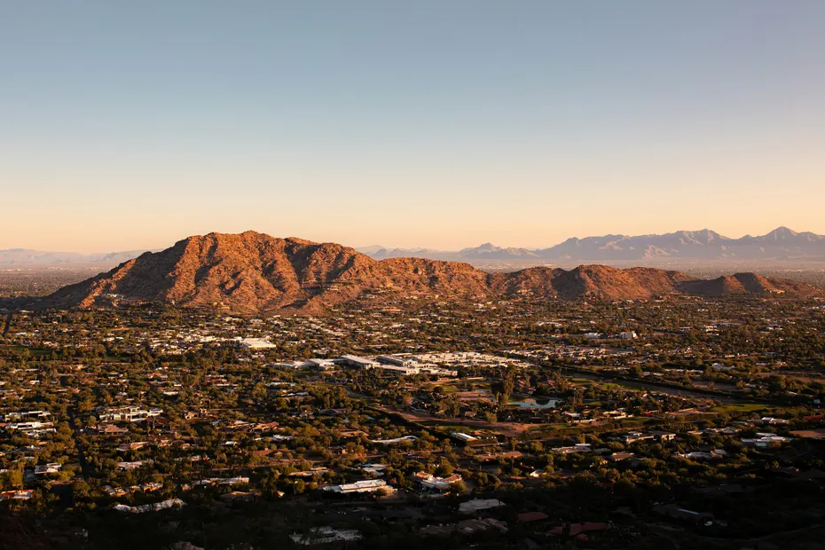 Phoenix seen from above at sunset, with the surrounding mountains behind it